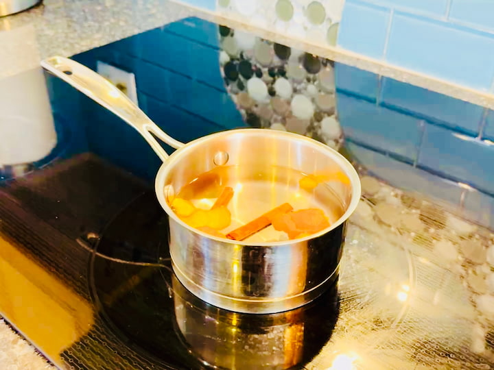 fill a small pot with water, add some orange slices and cinnamon sticks, and let it simmer on low heat.