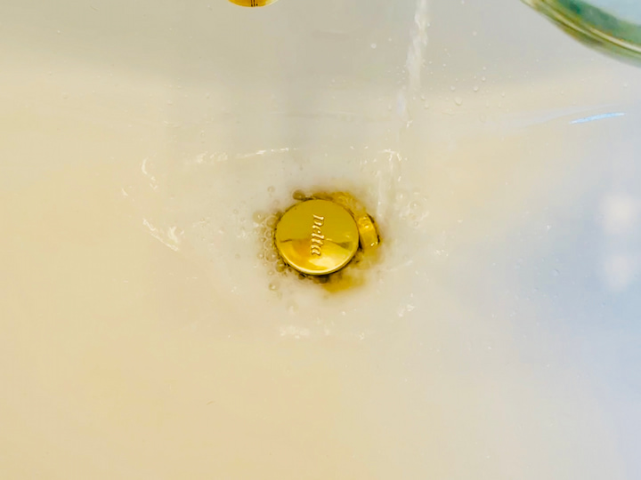 Pouring vinegar down sink drain