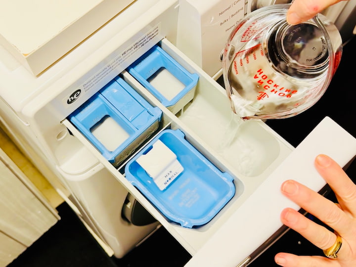 pouring vinegar in washing machine compartment