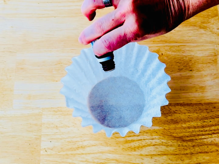 essential oil dripping onto a coffee. filter