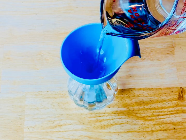 pouring water into spray bottle