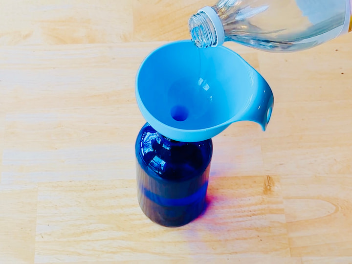 pour vinegar into a bottle