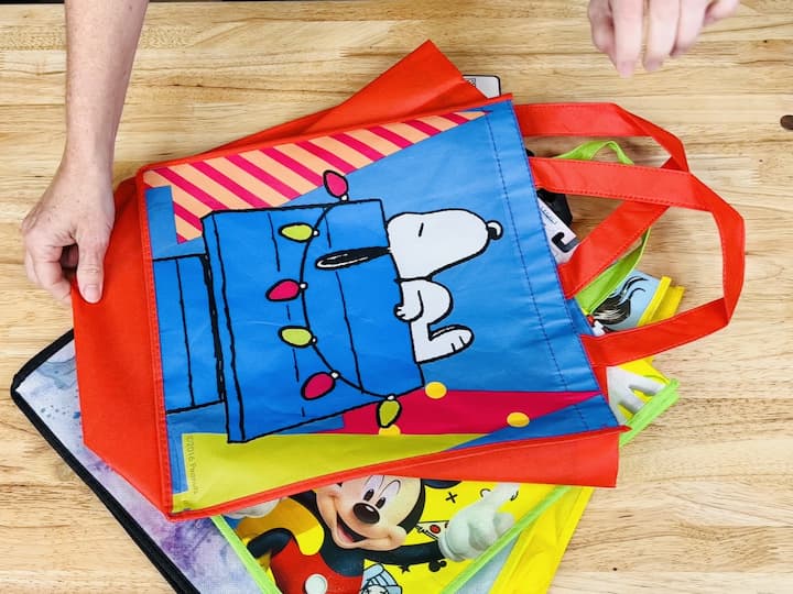 Opt for reusable gift bags to reduce waste. Use a magazine rack or book container from the dollar store to neatly store them. 