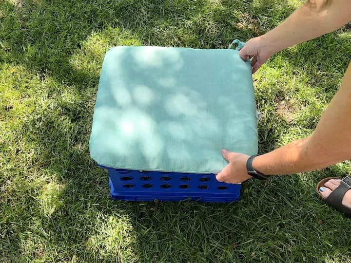 Place an inexpensive seat cushion on top for some extra seating.  You can make as many of these as you like and then the best part is that you can stack them away when you're done with the cushions inside.