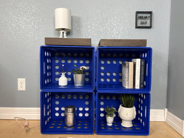 You can pick a color of crates that you like whether you like bright and vibrant or more subtle.  You can also paint the crates any color you like with a little spray paint.  Here you'll see I build a little storage shelf that can hold books or other display items.  I placed a couple of inexpensive serving trays on top, or you can measure the top and have a local hardware store cut a board to size to place on top.