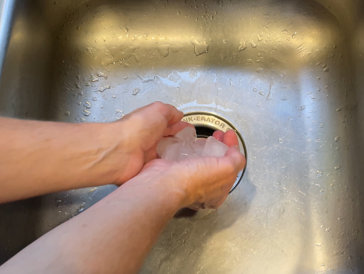 Now we're going to talk about the garbage disposal. I have frozen some vinegar into ice cubes, and you could alternatively use lemon juice or a combination of vinegar and lemon juice.  For this one I'm going to place the ice cubes into the garbage disposal turn the water on and run the garbage disposal.  This cleans the blades and deodorizes your garbage disposal. 