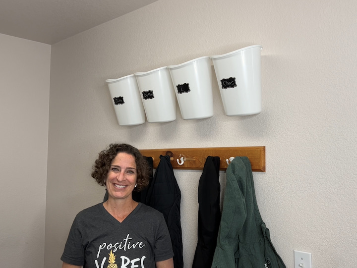 A lot of times in different areas of your home you have an underutilized wall space that could be great for a project like this.  As you can see here we have an over-the-door hanging rack and we've used it for hats so these hats are grab and go really quickly to get out the door for summer and sun protection. 