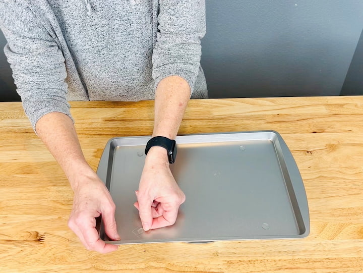 8.  Place adhesive on top of the baking pan