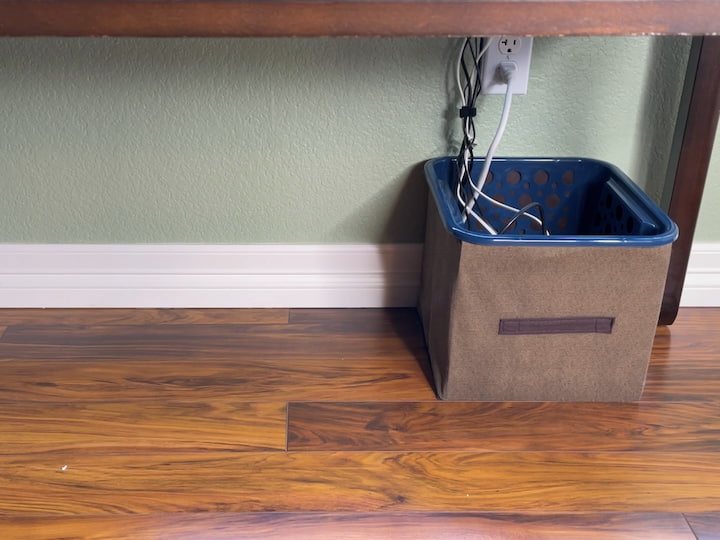 I wound all the cords together with a velcro tie and placed a command cord hook at the top that would keep all of the cords together so they're hidden and this helps keep my desk looking a little cleaner underneath.