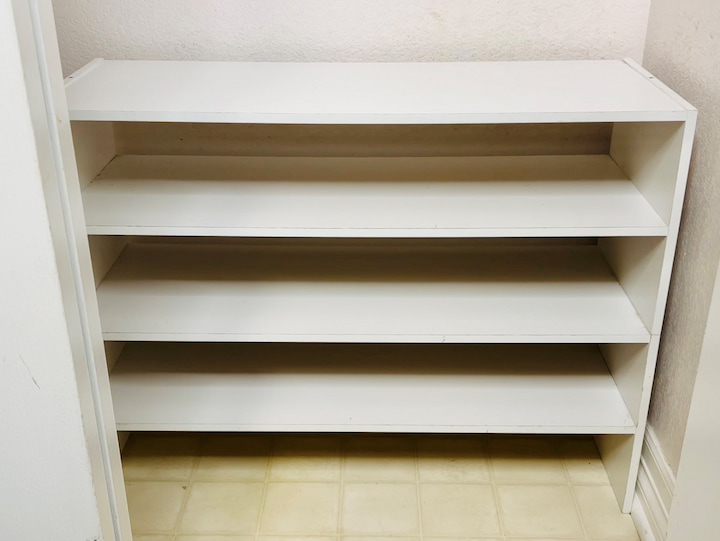 I measured my closet and I found this shoe organizer that fits perfectly at the bottom of the closet. You could use open shoe racks if you prefer. Because there are four of us that live in this home I grouped everybody's shoes together.