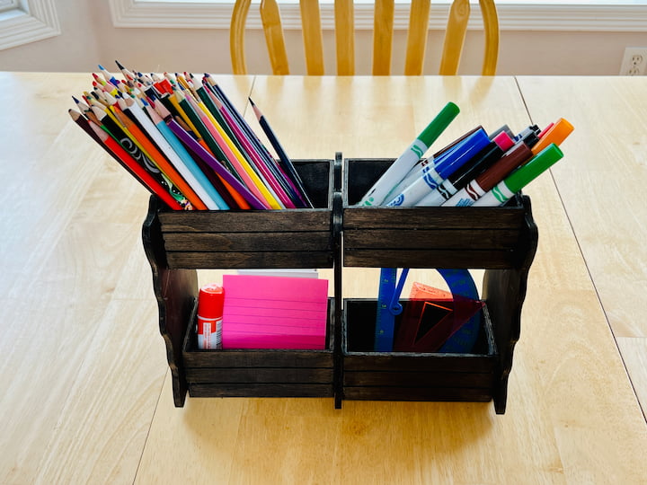 I placed it on my kitchen counter and added colored pencils, markers,  post-it notes, glue and rulers for a craft or school station.  