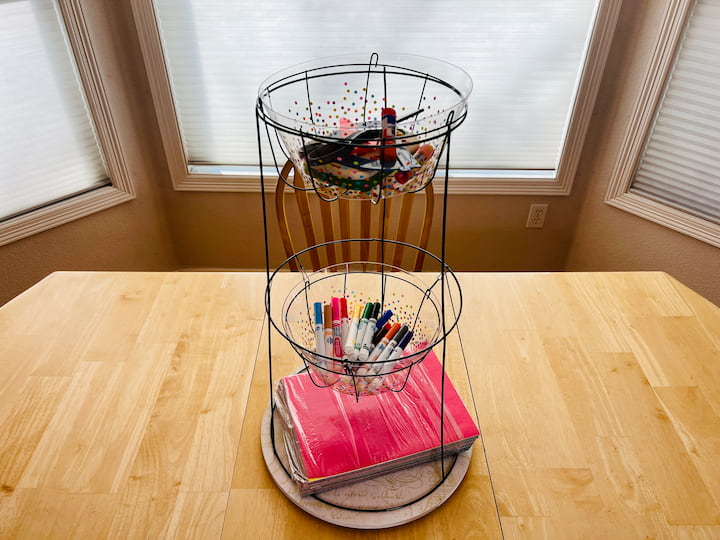 This is great for kids' activities or homework stations.   Simply place it on top of a lazy Susan.   I added construction paper on the bottom,  some markers in the center and scissors rulers, and glue at the top.  Because I put it on the Lazy Susan it also swivels for convenience.