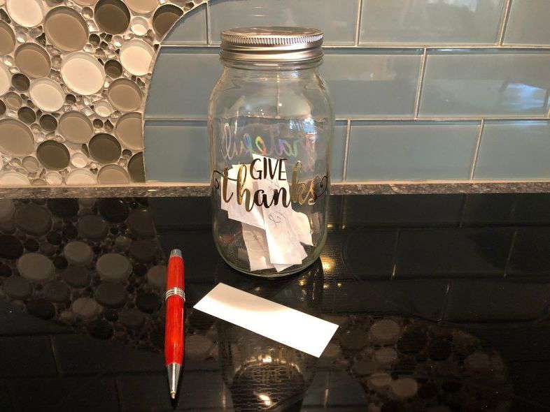 jar with stickers and hand written notes inside