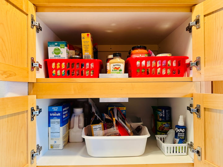 dollar store baskets holding pantry items for easy sliding in and out